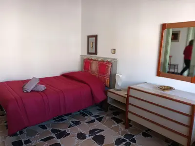 Letto o letti in una camera di Casa Bellini Oristano