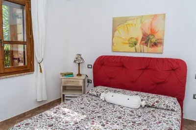 Letto o letti in una camera di Villetta il Carrubo vista mare