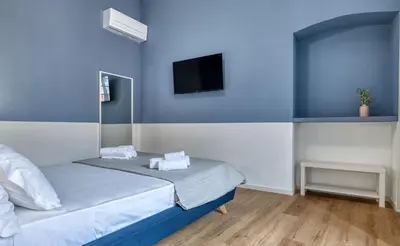Letto o letti in una camera di IzzHome Corso76
