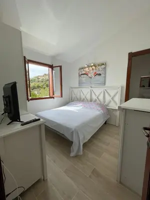 Letto o letti in una camera di Villetta Azzurra Kal'è Moru