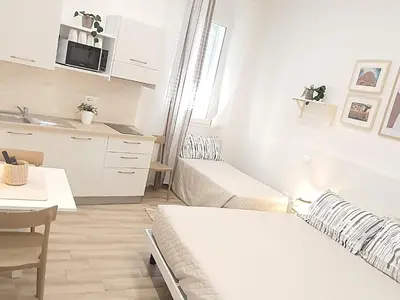 Letto o letti in una camera di SUITE BLANC APARTMENTS - Monolocali indipendenti con cucina e bagno privato - Check-in e check-out con codice in autonomia h24 - Terrazza in comune NECESSARIO AVERE WATHSAPP O APP DI MESSAGGISTICA ISTANTANEA PER FOTO E VIDEO