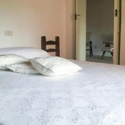 Letto o letti in una camera di Beni benius - Typical restored house in Nurachi