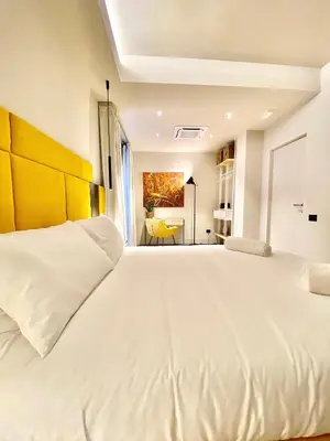Letto o letti in una camera di VicomilleSuites Cagliari Adults-Only
