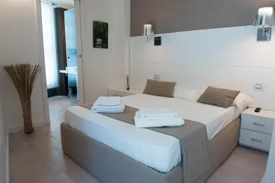 Letto o letti in una camera di Rigel Villanova Rooms