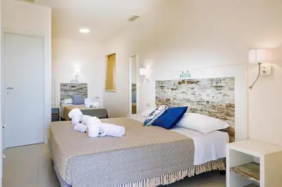 Letto o letti in una camera di Mercury Beach Hotel