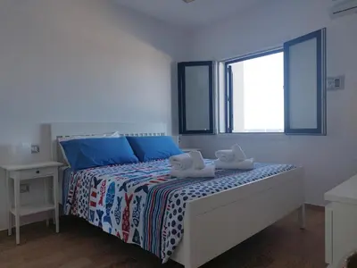 Letto o letti in una camera di Sky and Sea Apartment Calasetta