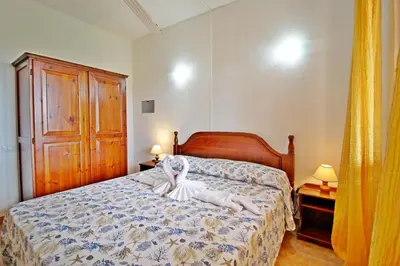 Letto o letti in una camera di Costa Rei Villette Rei Marina con wi-fi
