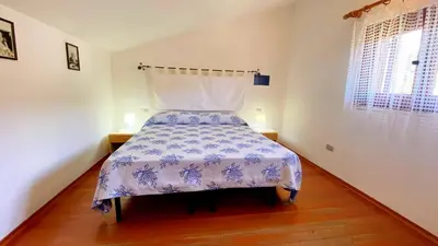 Letto o letti in una camera di Villetta Alba Costa Rei