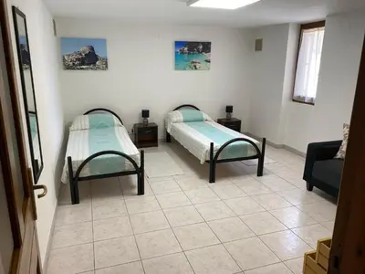 Letto o letti in una camera di Appartamento con giardino e parcheggio privato Musci