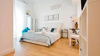 Letto o letti in una camera di KRLY Rooms Cagliari - Parcheggio in centro storico