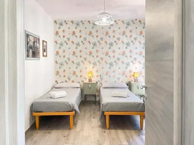 Letto o letti in una camera di Affittacamere DOMO AGORA'