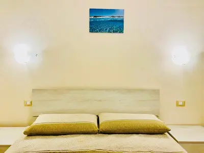 Letto o letti in una camera di Nuova Residenza dei 7 Pini a pochi passi dal mare