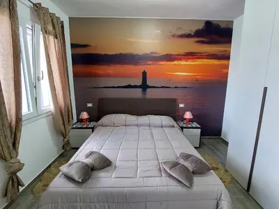 Letto o letti in una camera di Ca' Maraisci, incantevole appartamento vista mare