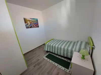 Letto o letti in una camera di Ca' Maraisci, incantevole appartamento vista mare
