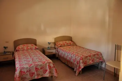 Letto o letti in una camera di B&B L'Asfodelo
