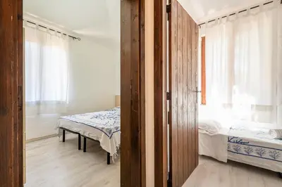Letto o letti in una camera di Elegante Villa a 30 m dalla bellissima spiaggia di Campulongu Villasimius