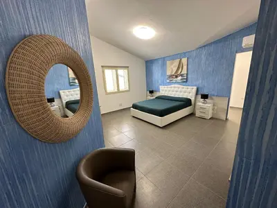 Letto o letti in una camera di LXR Rooms Carloforte