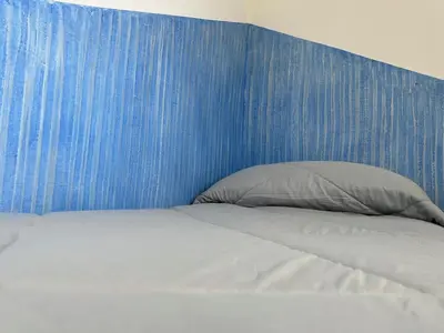 Letto o letti in una camera di LXR Rooms Carloforte
