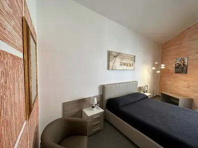 Letto o letti in una camera di LXR Rooms Carloforte