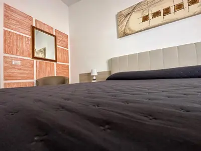 Letto o letti in una camera di LXR Rooms Carloforte
