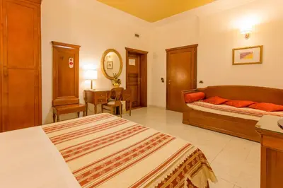 Letto o letti in una camera di Mariano IV Palace Hotel