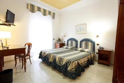 Letto o letti in una camera di Mariano IV Palace Hotel
