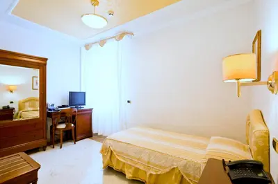 Letto o letti in una camera di Mariano IV Palace Hotel