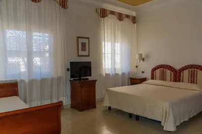 Letto o letti in una camera di Mariano IV Palace Hotel