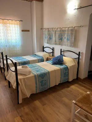 Letto o letti in una camera di AZIENDA AGRITURISTICA S'ARGALASI - B&B - AFFITTACAMERE Loc S'Argalasi Austis