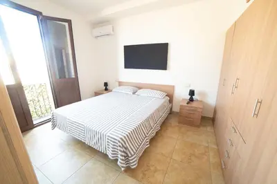 Letto o letti in una camera di WEST SARDINIA APARTMENT 3