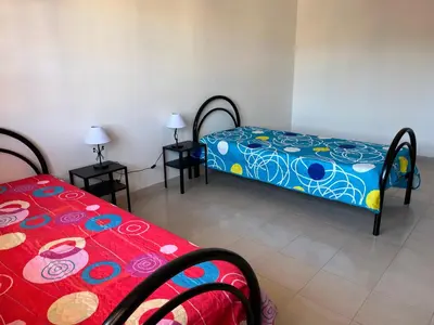 Letto o letti in una camera di Casa Vacanze Costa Ovest