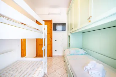 Letto o letti in una camera di Villa Bibi Villasimius - con giardino