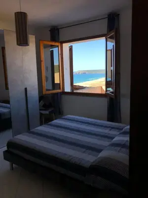 Letto o letti in una camera di La Villa dell Artista con vista mare e dune - IUN Q7440