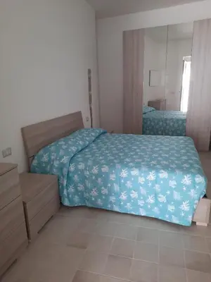 Letto o letti in una camera di Appartamento su palazzina storica in centro a Sant'Antioco