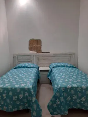 Letto o letti in una camera di Appartamento su palazzina storica in centro a Sant'Antioco