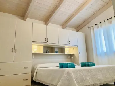 Letto o letti in una camera di IL TRAMONTO
