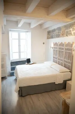 Letto o letti in una camera di B&B Terra - Stanza Viaggio