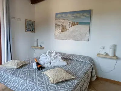 Letto o letti in una camera di L'Attico Villasimius