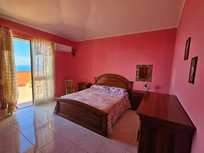 Letto o letti in una camera di Casa con magnifica vista mare