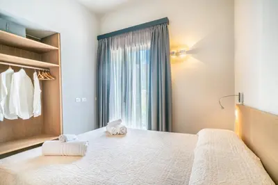 Letto o letti in una camera di Villa Kòsmos - Piscina e Giardino - Villasimius