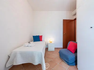 Letto o letti in una camera di Casa Adele - Steps to Cala Sinzias Beach
