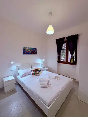 Letto o letti in una camera di Villetta indipendente Simius