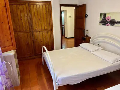 Letto o letti in una camera di Villetta Porto Pino 30 mt dalla spiaggia