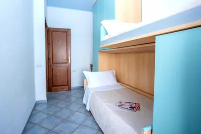 Letto o letti in una camera di Villa sul mare Porto Corallo