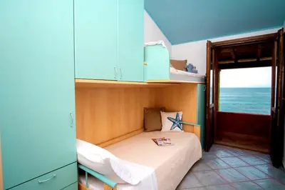 Letto o letti in una camera di Villa sul mare Porto Corallo