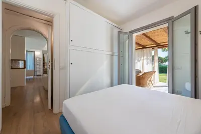 Letto o letti in una camera di DOMUS MARIS Villa Charmant Porto Giunco Notteri VILLASIMIUS