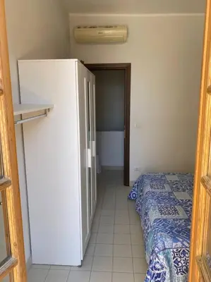 Letto o letti in una camera di Casa Leonardo, a panoramic view of Cagliari with free car parking