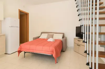 Letto o letti in una camera di Casa Katia Vacanze Oristano, a pochi minuti dalle spiagge più belle della Sardegna e pochi minuti da Oristano, casa dotata di tutti i comfort
