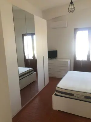 Letto o letti in una camera di Fausthome Sant'Antioco