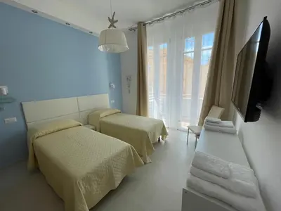 Letto o letti in una camera di XOXO Cagliari